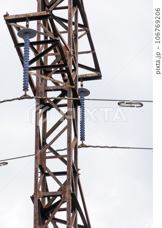 Close-up of a high voltage tower with loop type insulators and dampers. 106769206