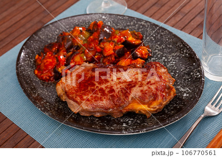 Roasted veal entrecote with side dish of stewed vegetables Roasted veal entrecote with side dish of stewed vegetables 106770561