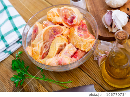 Uncooked chicken and condiments on kitchen table Uncooked chicken and condiments on kitchen table 106770734
