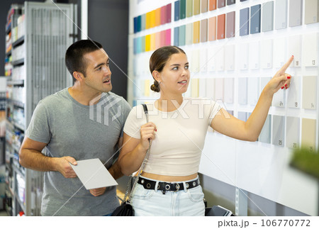 Married couple chooses ceramic tiles for kitchen or bath at hardware store Married couple chooses ceramic tiles for kitchen or bath at hardware store 106770772
