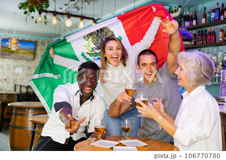 Diverse group celebrating with Mexican flag 106770780