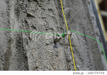 cement plaster texture background with green and yellow thread cement plaster texture background with green and yellow thread 106774759