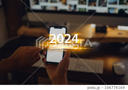 New Year 2024 celebration concept,Smartphone and work desk at home background 106776169