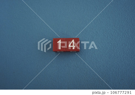 Wooden Viva Magenta cubes with number 14 on blue background close-up top view. Concept of date or time. White numbers 14 Wooden Viva Magenta cubes with number 14 on blue background close-up top view. Concept of date or time. White numbers 14 106777291