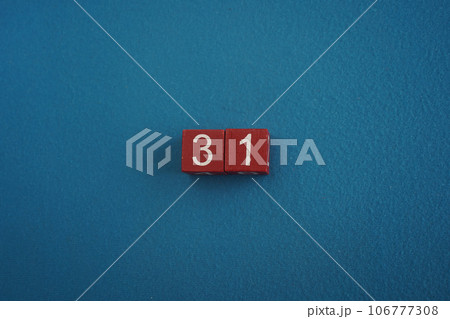 Wooden Viva Magenta cubes with number 31 blue background close-up top view. Concept of date time. White numbers 31 Wooden Viva Magenta cubes with number 31 blue background close-up top view. Concept of date time. White numbers 31 106777308