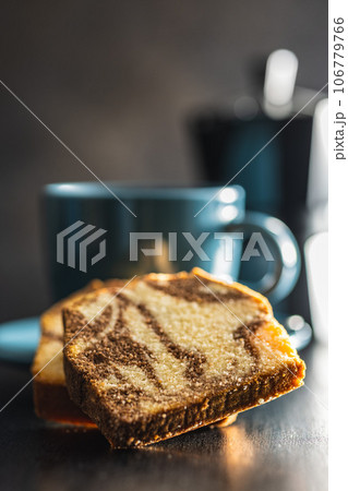 Marble sponge cake and coffee cup. Cake with cocoa and vanilla taste. Marble sponge cake and coffee cup. Cake with cocoa and vanilla taste. 106779766