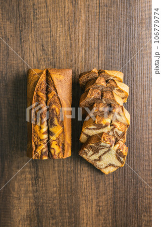 Marble sponge cake. Cake with cocoa and vanilla taste on wooden table. Top view. 106779774