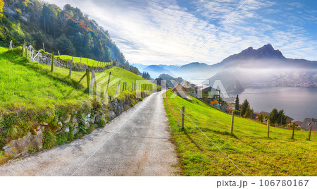 Exciting autumn view on suburb of Stansstad city and Lucerne lake with mountaines and fog Exciting autumn view on suburb of Stansstad city and Lucerne lake with mountaines and fog 106780167