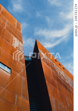 Facade of European Solidarity Centre building, Europejskie Centrum Solidarnosci in Gdansk Poland. Exterior on blue sky background. Monument to the fallen Shipyard Workers 1970 Old town. Museum Facade of European Solidarity Centre building, Europejskie Centrum Solidarnosci in Gdansk Poland. Exterior on blue sky background. Monument to the fallen Shipyard Workers 1970 Old town. Museum 106781154