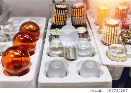 Assorted LED car lamps and incandescent car lamp lie on the shelf of an auto store Assorted LED car lamps and incandescent car lamp lie on the shelf of an auto store 106783267
