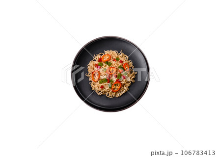 Delicious fresh noodles with sweet pepper, tomato, spices and herbs 106783413