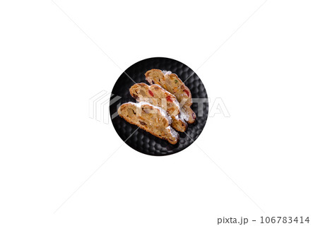 Christmas pie stollen with marzipan, berries and nuts on a dark concrete background Christmas pie stollen with marzipan, berries and nuts on a dark concrete background 106783414