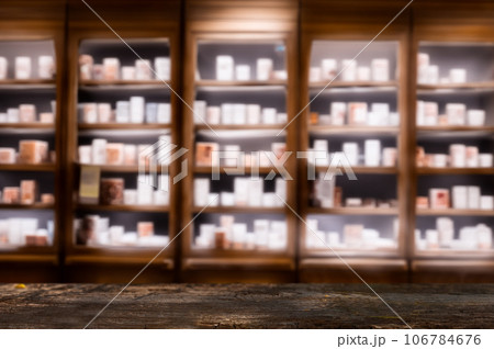 Dark Wooden Counter with Blurred Pharmacy Shelves ideal for product presentations or mockups. 106784676