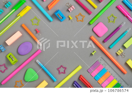 Round frame of colorful rainbow school and office stationery set on gray background. Flatly, copyspace. 106786574