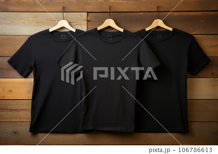 3 black t shirts on wood background. Generative ai. 106786613