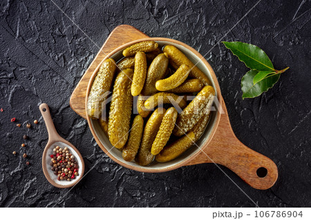 Pickled cucumbers with pepper and bay leaf. Fermented food 106786904
