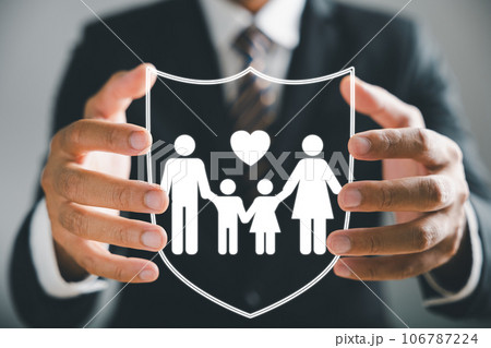 Insurance concept brought to life, Businessman with protective gesture ensures family security, incorporating life, health, and house coverage. Icons emphasize family life insurance and policy concept 106787224