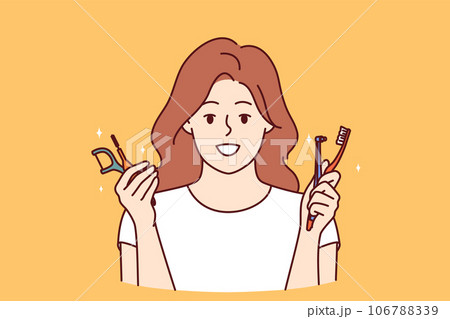 Happy woman holds brushes and tools for cleaning teeth and gums, calling for good hygiene 106788339