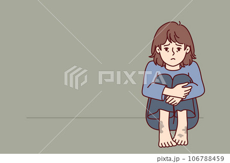 Sad poor girl with dirty feet sits on floor and is sad because of lack of home and money for food 106788459