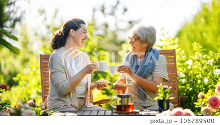 women drinking tea in the garden women drinking tea in the garden 106789500