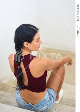 Portrait of ukrainian woman with braids looking at camera against white background 106790330