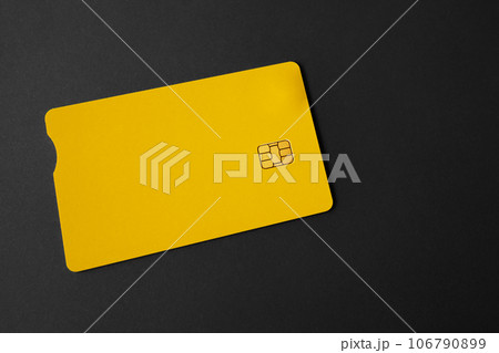 Green plastic bank card on a gray background. Mockup. Plastic card with chip. 106790899