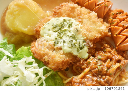 crispy fried chicken meat stuffed cheese with mash potato dressing gravy sauce and spaghetti and cabbage cos lettuce salad couple sausage on plate crispy fried chicken meat stuffed cheese with mash potato dressing gravy sauce and spaghetti and cabbage cos lettuce salad couple sausage on plate 106791841