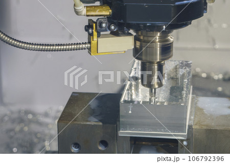The CNC milling machine rough cutting the aluminum housing with flat end mill tool. The CNC milling machine rough cutting the aluminum housing with flat end mill tool. 106792396