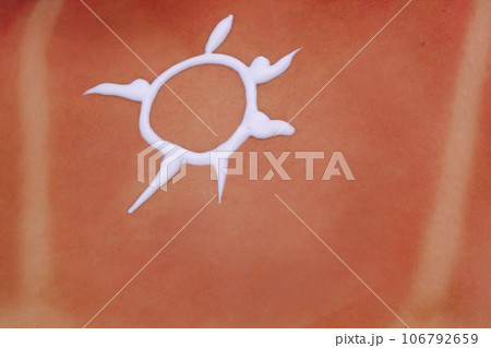 Close-up of picture of sun painted with sun block lotion on naked back of woman. Skin protection, moisturizing cream. Close-up of picture of sun painted with sun block lotion on naked back of woman. Skin protection, moisturizing cream. 106792659