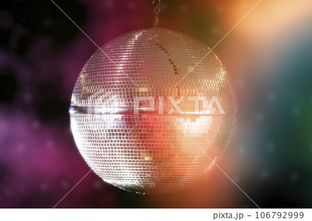 Disco ball with bright beams, night party background photo. Disco ball with bright beams, night party background photo. 106792999