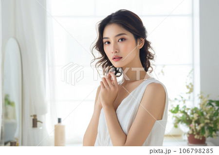 Beautiful asian woman with clean fresh skin taking care of face and body skin in bathroom 106798285