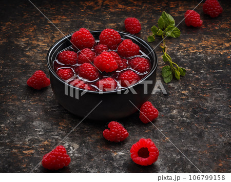 close up raspberry in juice complex background 106799158