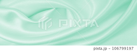 Smooth elegant green silk or satin luxury cloth texture as abstract background. Luxurious background design Smooth elegant green silk or satin luxury cloth texture as abstract background. Luxurious background design 106799197