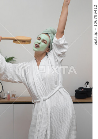 Spa Day Groove: Wrapped in her bathrobe with a clay mask, she lets loose, singing into a hairbrush and dancing with a towel on her head, pure delight. Spa Day Groove: Wrapped in her bathrobe with a clay mask, she lets loose, singing into a hairbrush and dancing with a towel on her head, pure delight. 106799412
