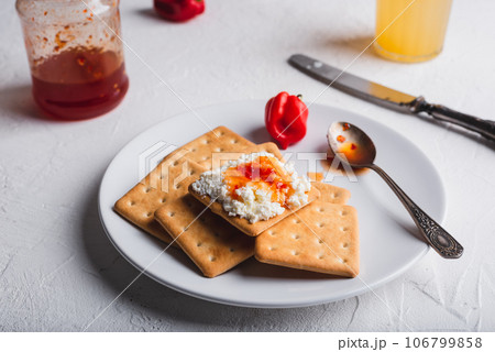 Hot Pepper Jam with Cream Cheese on Crackers 106799858