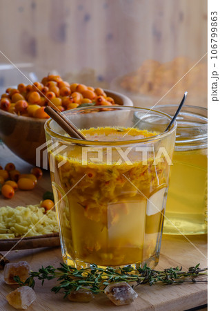 sea buckthorn honey ginger mix in glass with cinnamon 106799863