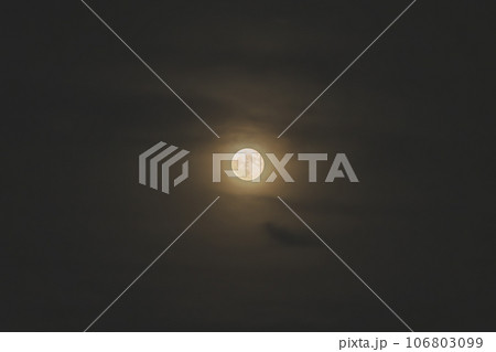 雲の隙間から見える満月 106803099