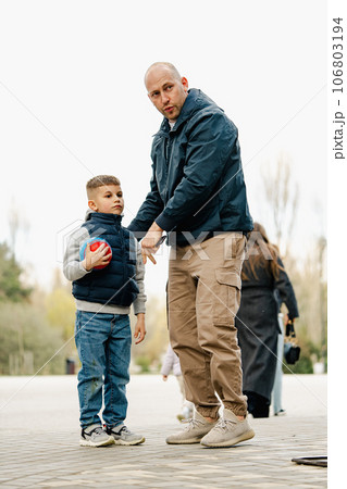 Father and his son on a walk in the park 106803194