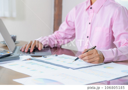 Businessmen bookkeeper hand holding pen doing account for paying tax in working office 106805185