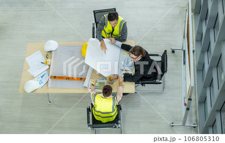 Engineer team is meeting to inspect the construction blueprint drawings, work plan and distribute work before starting the building. 106805310