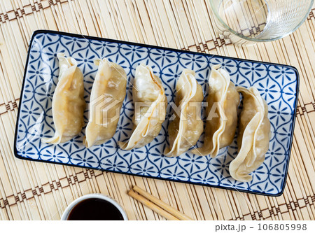 Steamed dumplings gyoza with meat filling served with sauce 106805998