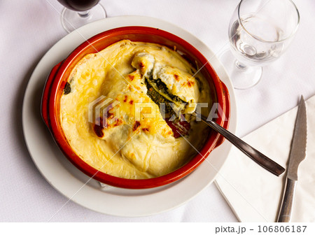 Traditional dish of Italian cuisine is spinach lasagna 106806187