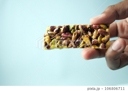 hand holding a chocolate and oats protein bars  106806711