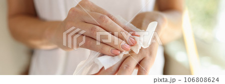 Woman cleans hand with wet wipes close up. Woman cleans hand with wet wipes close up. 106808624