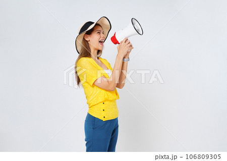 Young  woman wearing sun hat and holding megaphone isolated on white background. Lifestyle summer and announce concept. 106809305