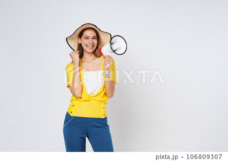 Young  woman wearing sun hat and holding megaphone isolated on white background. Lifestyle summer and announce concept. 106809307