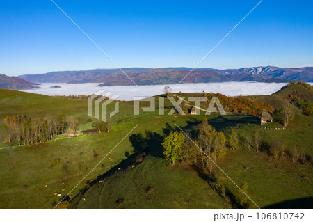Mountain countryside homestead in the autumn. Wooden barns, aerial drone view 106810742