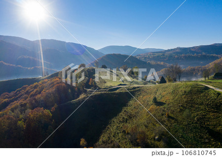 Aerial view of autumn countryside farm, with abandoned wooden houses and barns in the mountains 106810745