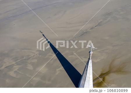 Abstract aerial view of church tower with cross and shadow, flooded by copper mining residuals and mud Abstract aerial view of church tower with cross and shadow, flooded by copper mining residuals and mud 106810899