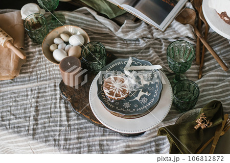 Christmas table with ginger cookies and rustic dishes. Flat lay Christmas table with ginger cookies and rustic dishes. Flat lay 106812872